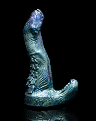 Adder the basilisk, a snake inspired dildo with a clitoral stimulator. This fantasy dildo is shown in 2 of our custom shimmery colors.