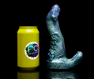 Adder the basilisk, a snake inspired dildo with a clitoral stimulator. Shown next to a soda can for size reference. 