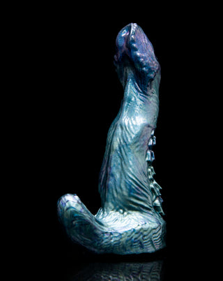 Adder the basilisk, a snake inspired dildo with a clitoral stimulator. This fantasy dildo has a snake inspired head with scales down the back.